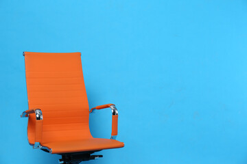 Comfortable office chair on light blue background, space for text