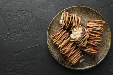 Delicious chocolate puffed rice bars on dark gray textured table, top view. Space for text