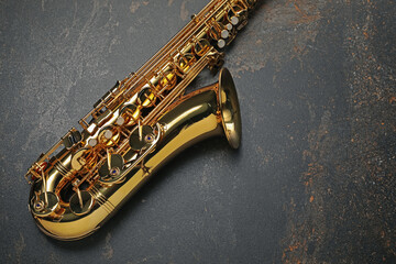 Jazz. One saxophone on black textured table, top view. Space for text