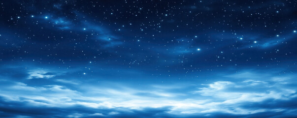 A clear blue sky with a few clouds and a few stars. The sky is very dark and the stars are very bright
