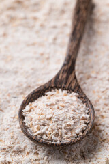Whole wheat flour in spoon with flour background