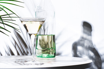 Italian white bianco vermouth in glass and bottle on white background