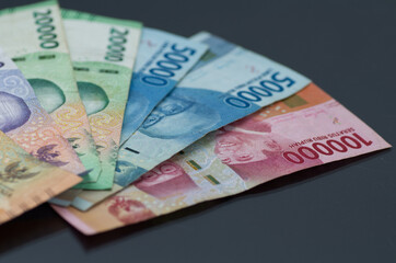 Assorted Indonesian Rupiah Banknotes on a Dark Background