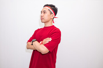 Confident Indonesian Male Posing With Cross Arm Gesture In Casual Outfit Embracing Nationalist Values During Independence Day Celebration.