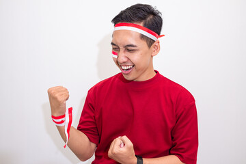 Energetic Young Man Excited to Celebrate Indonesian Independence Day, Showing National Pride with Flag Face Paint.