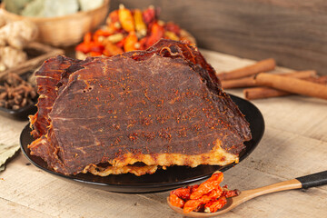 Dried beef crisps, beef crisps on a wooden background