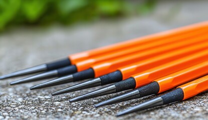 Closeup of several orangehandled metal punches