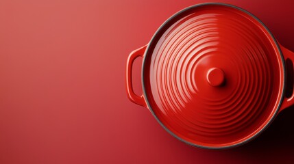 Fototapeta premium A vibrant red cooking pot on a matching background for culinary inspiration.