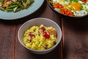 with traditional Jewish dishes for the holiday on the table chelnt couscous tzimmes