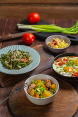 A set table, tzimmes, chelnt, shakshuka and couscous with dried fruits