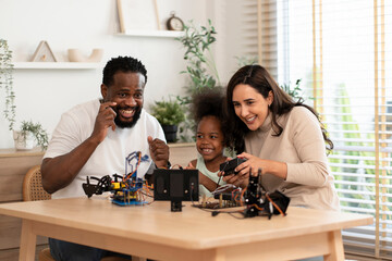 family having fun,parents help kid learning robot circuit,electronic board cable in STEM subject,concept family lifestyle,adult help kid,homeschooling