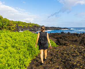 Female Hiker on Volcanic Shoreline of The Kings Trail Near Kauiau Point, Waianapanapa State Park,...