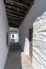 Whitewashed passageway with wooden beams