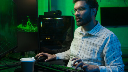 Tired sleepy Indian Arabian man worker typing keyboard computer late night home office male guy yawning businessman business programmer coder trader drinking coffee overwork hacker yawn sleep insomnia