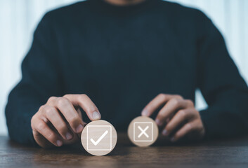 Businessman thinking and deciding between right and wrong symbols. Voting decision. Yes or no...