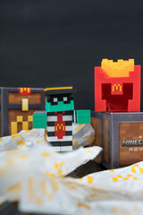 Fototapeta premium Bangkok, Thailand - April 8, 2025 : Zombie hamburglar and Minecraft fries helmet, Minecraft blind box from McDonald's collaborates.