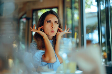 Bothered Woman Covering her Ears in la Loud Restaurant. Person being exasperated by the music at a...