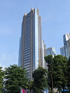 Batam, Indonesia - April 9, 2025: Photos of office buildings and apartments in the city of Jakarta with greenery during the day.