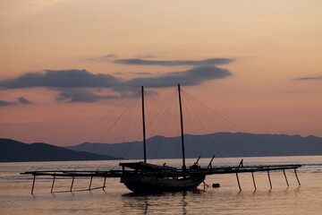 Beautiful sunset over the ocean in Labuan Bajo, Indonesia&mdash;serene tropical seascape with warm golden light and peaceful atmosphere.
