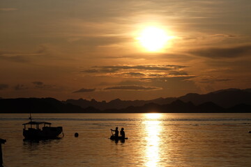 Beautiful sunset over the ocean in Labuan Bajo, Indonesia&mdash;serene tropical seascape with warm golden light and peaceful atmosphere.