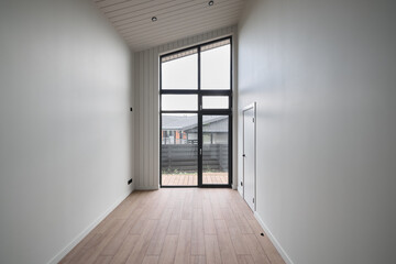 The design features modern minimalist interiors with large windows for natural light and warmth