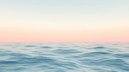 Long exposure shot of calm ocean waves beneath a fading sunset sky in pastel colors