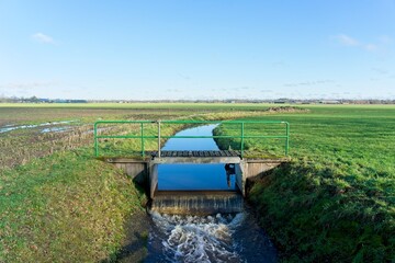 Sluice dewatering water from the farm fields of the Gelderse Vallei between the hills of the Veluwe in Gelderland and the Utrechtse Heuvelrug in Utrecht in the Netherlands
