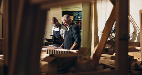 Carpenter, teamwork and men with tablet, manufacturing and helping intern with wood work and...