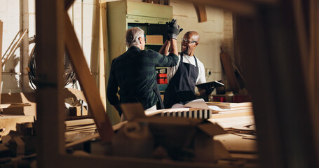 Carpenter, men and high five for work, skills and helping intern with tablet, woodwork and...