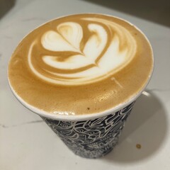 Brown and White Latte Coffee Art in a Blue and White Cup