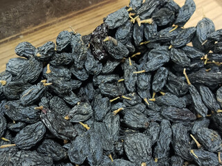 Black dried raisins close-up. Dried grapes. The benefits of dried fruits. 