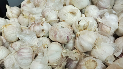 A bunch of white garlic in close-up. Allium sativum. Garlic for cooking spicy dishes. 