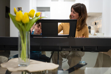 Mother and son having fun playing digital piano at home © oscar