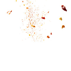 Red pepper flakes falling on black background spice explosion culinary art