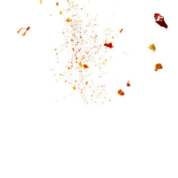 Red pepper flakes falling on black background spice explosion culinary art