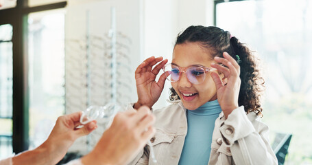 Happy child, glasses and optometry with lens for eyesight, vision aid or care at optometrist shop. Girl, kid or spectacles with smile for eyewear advice, service or assistance at optician store