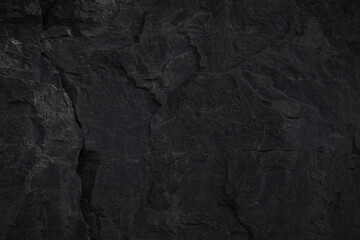 A textured stone background showcasing a brutal, monolithic rock formation with cracks and fragments. Perfect for design templates, banners, or projects highlighting natural power and beauty.