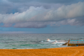 Fototapeta premium Sunrise at the Seaside with rain clouds