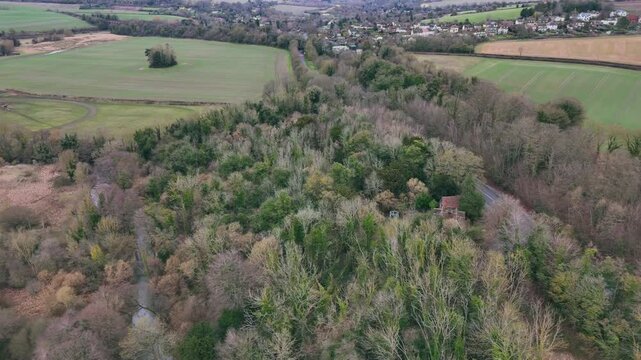 Aerial view of the dense vegetation with vast rural fields of Shoreham village in Kent, England