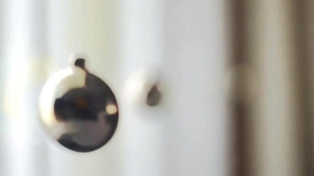 Cinematic close-up of a swinging metallic pendulum in slow motion with soft background blur, ideal for sleep videos, meditation visuals, ASMR content, and relaxation scenes