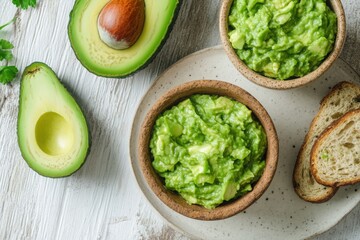 Top View of Homemade Guacamole Dip in Rustic Bowls with Sliced Avocado and Bread