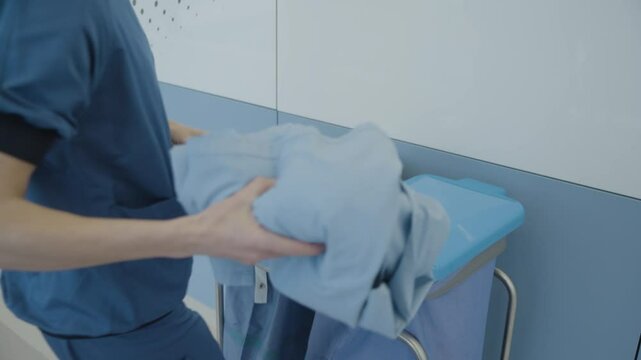 Footage showing hospital staff discarding clean or unused medical clothing and gloves, highlighting unnecessary waste in healthcare.