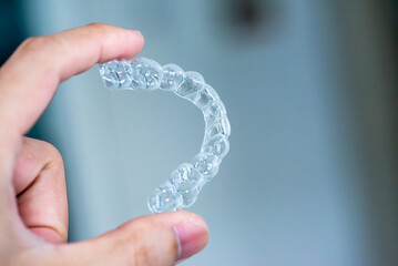  clear aligners device in the mouth on a white background. (invisalign)