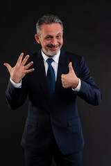 Businessman showing six fingers and thumbs up.