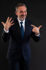 Cheerful businessman showing number seven with fingers.