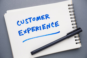 Customer Experience handwritten text as note in a spiral notebook