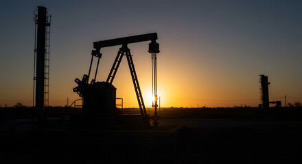 Silhouette of Oil Pumps Against a Vibrant Sunset Sky.