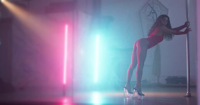 Butt, pole dancer and woman in nightclub with music, burlesque or performance with neon lights. Erotic dancing, girl and artist moving for sensual art, sexy and shake with exotic body in lingerie