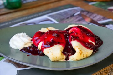 Pancakes with berries and ice cream on the table