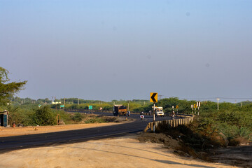 Light Traffic of Loaded Trucks on Highway Through Desert at Rann of Kutch